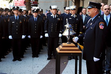 FDNY members stand at attention as a bell is tolled for each FDNY firefighter killed at the 23rd Street fire.