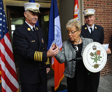 Chief of Department Edward Kilduff (left) and Queens Borough Commander John Sudnik receive the keys to the Mobile Training Vehicle from Borough President Helen Marshall.
