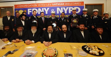 Chief James Leonard (holding plaque, center) and Chief James Yakimovich (holding plaque, right) receive an honor from the Congregation Yetev Lev Satmar.