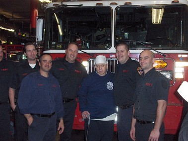 Members of the firehouse with John Russo after giving him a firehouse t-shirt and patch.