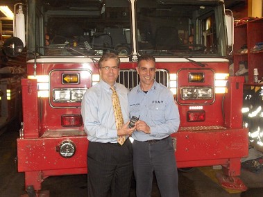Dan Heldridge (left) and FDNY Capt. Tom Frizalone. Mr. Heldridge is holding the cell phone that brought them together.