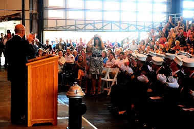 Catherine and Corinne Adissi (standing) are recognized by the Fire Commissioner during the ceremony. They attended the ceremony on behalf of Capt. Aldo Adissi, who is currently serving in Afghanistan.