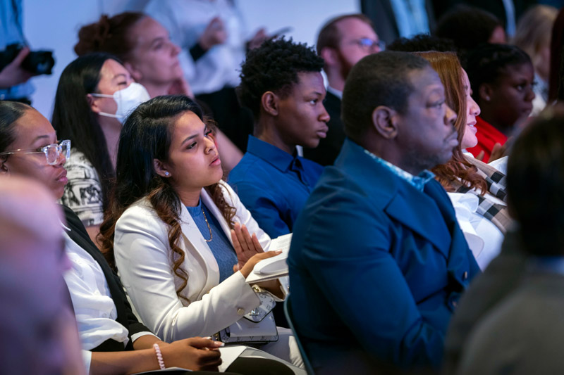 a crowd of people sitting a conference