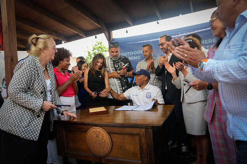 mayor adam is a white polo is giving a press briefing