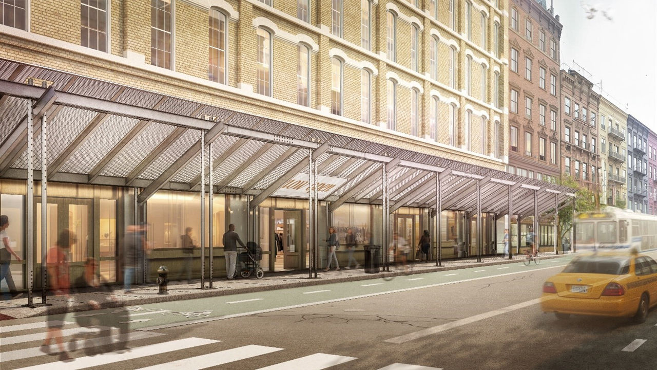 a street view of a row of yellowish building.