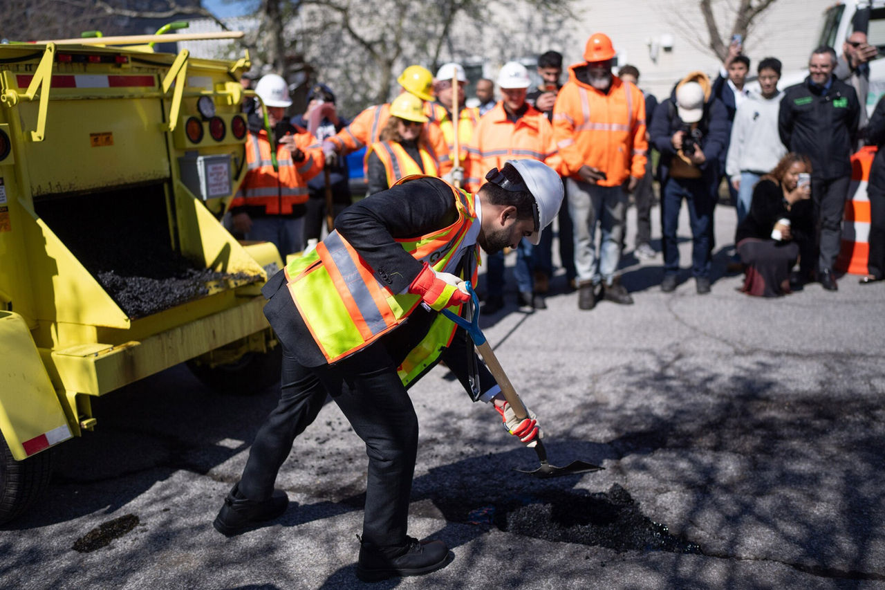 Mayor Mamdani fill a pothole with asphal