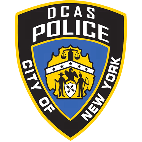 Black, white, blue and gold badge with scale, colonist & native American in the center surrounded by DCAS Police City of New York