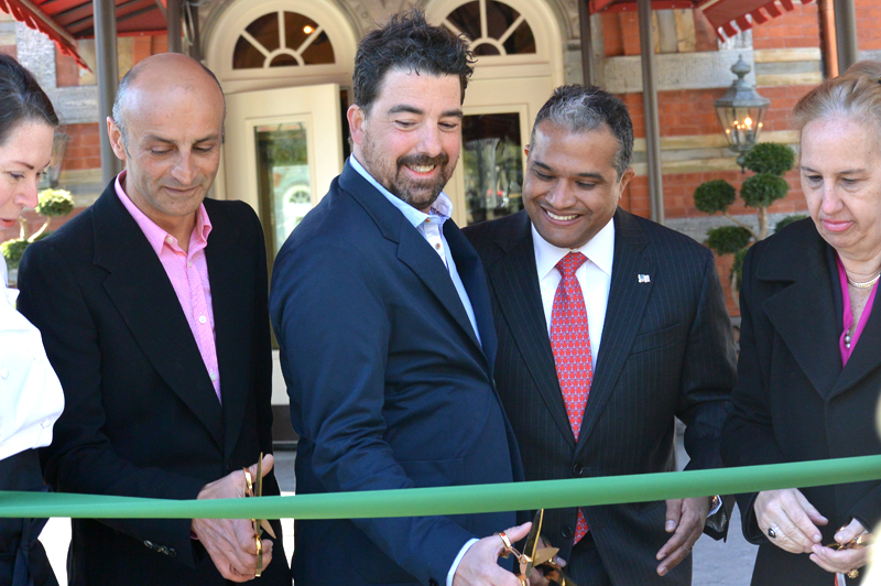 Commissioner Peña-Mora and other representatives cutting a green ribbon.
