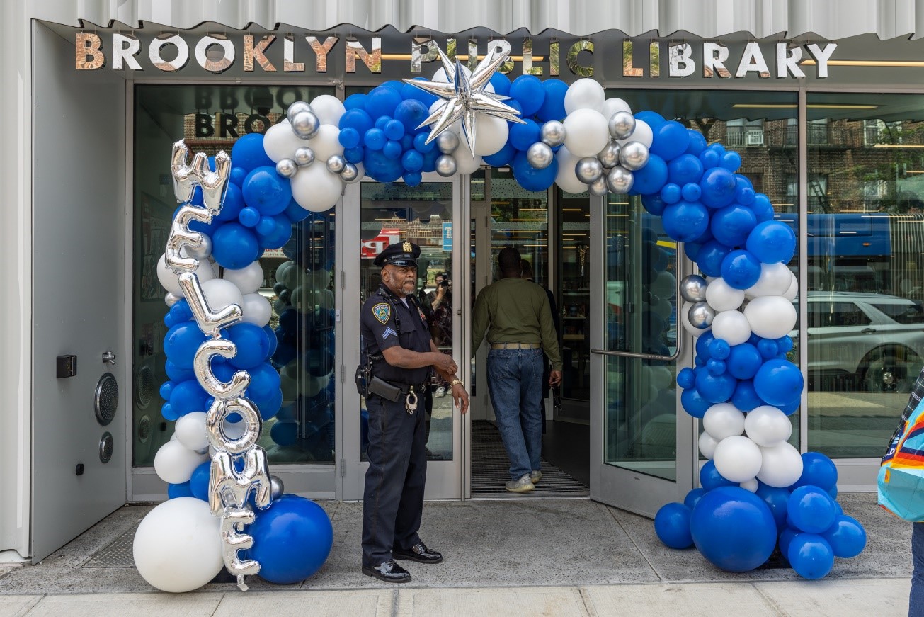 An officer stands at the entrance to the library