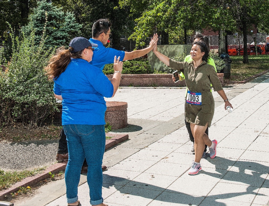 DDC employees encourage each other near Court Square during the 5k wellness walk