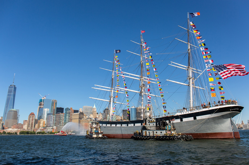 A far away shot of the Wavertree, decked out in international flags, as it floats in the NYC harbor.