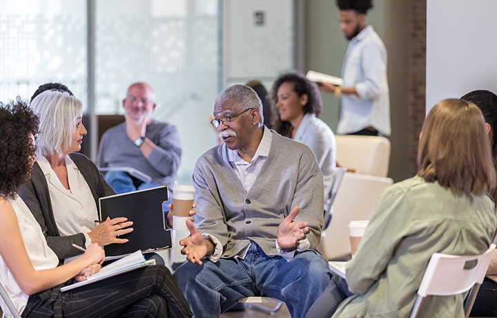 Photo of a several new yorkers sitting and having a discussion