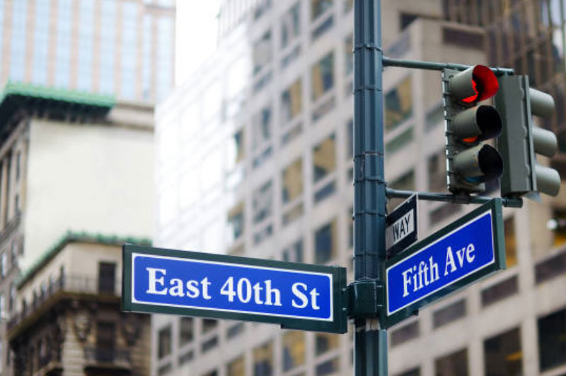 A photo of street signs at an intersection of East 40th Street and Fifth Avenue