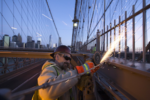 Department of Transportation employee performs maintenance on Brooklyn Bridge