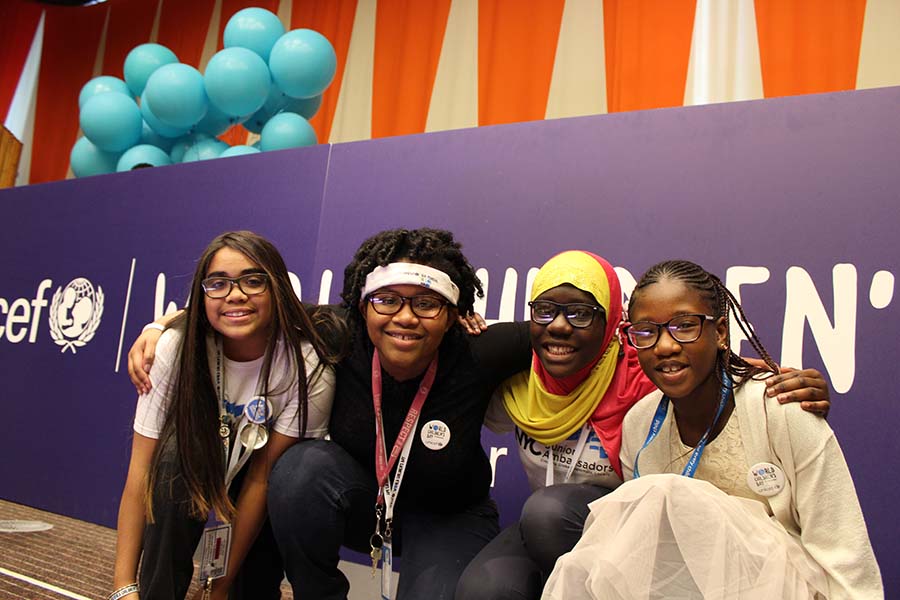 Four NYC Junior Ambassadors alumni pose together at the UNICEF World Children’s Day event
