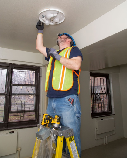 Worker Installs New Lighting - low angle
