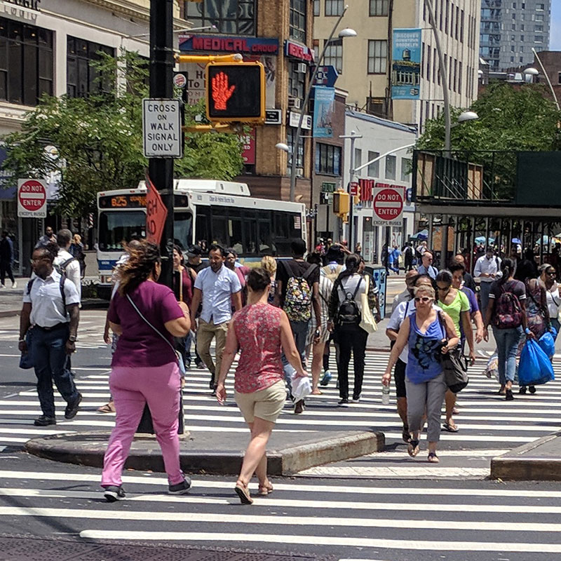 Crowd of people crossing a crosswalk