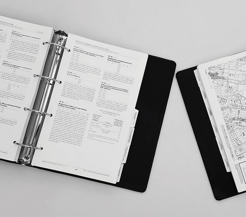 Open binders with text and maps