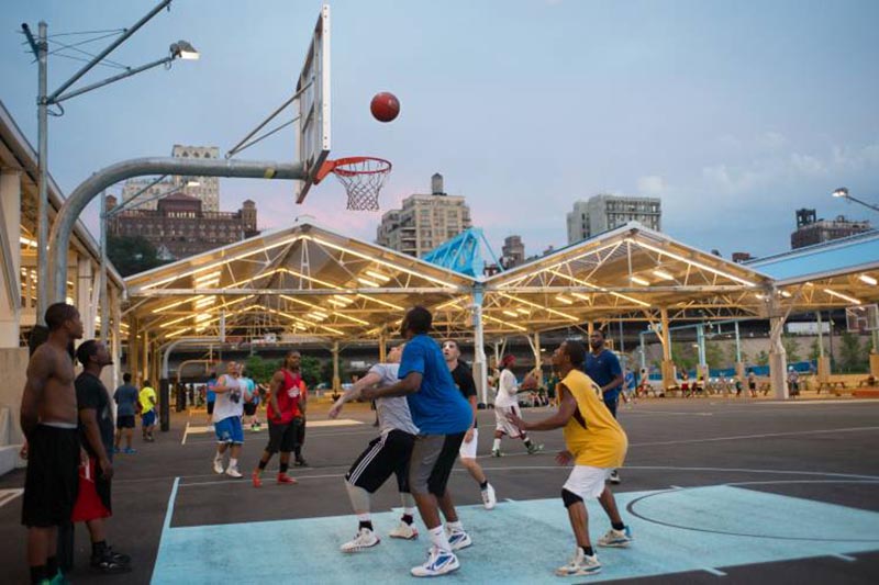Two Basketball teams playing at Saturday Night Lights