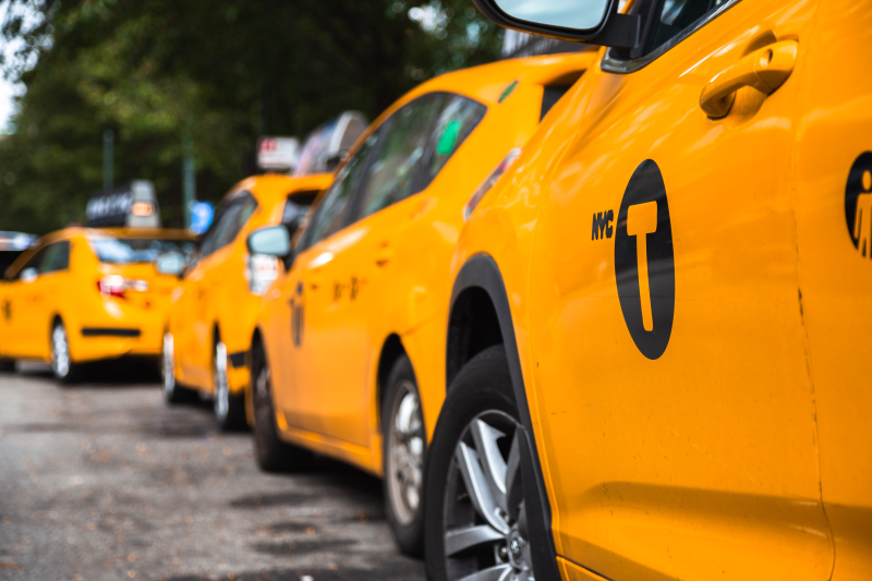 Four yellow Taxis lined behind each other. Four yellow Taxis lined behind each other