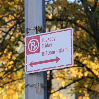 Alternate Side Parking regulation sign with a red circle with a P inside it and broom stick across it.