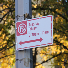 Alternate Side Parking regulation sign with a red circle with a P inside it and broom stick across it.