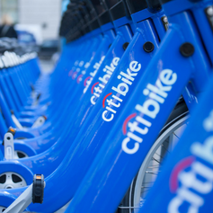 Close up of blue Citi Bikes parked in a row.