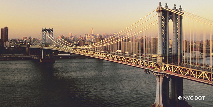 View of the Manhattan Bridge and New York city skyline at sunrise