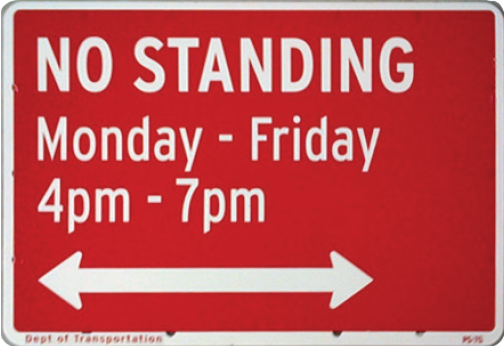 A red street sign with No Standing Monday-Friday 4pm-7pm and an arrow pointing in both directions