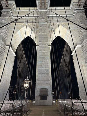 Closeup of the Brooklyn Bridge’s arches illuminated through NYC DOT’s new lighting system.