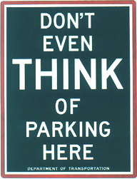 Don't Even Think Of Parking Here. Dark green background and white lettering.